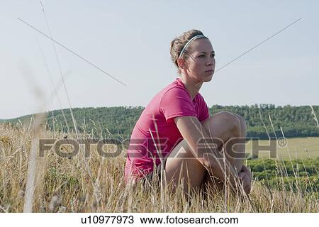 Woman seated on hillside, rural Manitoba, Canada View Large Photo Image Stock Image - Woman seated on hillside, rural Manitoba, Canada. Fotosearch
