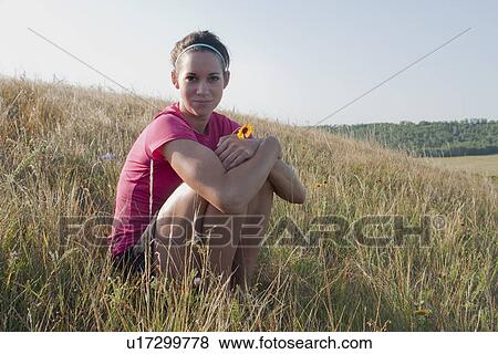 Woman seated on hillside, rural Manitoba, Canada View Large Photo Image Stock Photo - Woman seated on hillside, rural Manitoba, Canada. Fotosearch