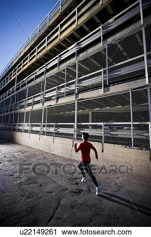 Woman sprints behind parkade, early morning, Regina, Saskatchewan View Large Photo Image Stock Image - Woman sprints behind parkade, early morning, Regina, Saskatchewan. Fotosearch