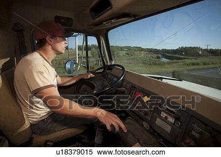 Stock Photography - Young farmer driving large grain truck, Redvers, Saskatchewan, Canada. Fotosearch