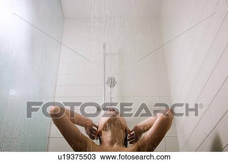 Stock Image - Young girl in low-flow shower. Fotosearch