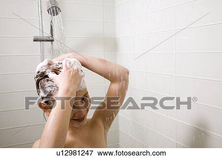 Stock Photo - Young girl in low-flow shower. Fotosearch