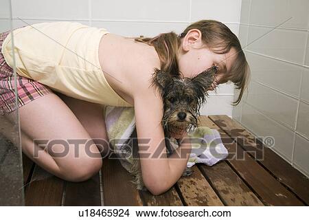Young girl towelling off small dog in shower stall View Large Photo Image Picture - Young girl towelling off small dog in shower stall. Fotosearch