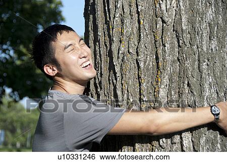 Young man hugs tree, Assiniboine Park, Winnipeg, Canada View Large Photo Image Stock Photograph - Young man hugs tree, Assiniboine Park, Winnipeg, Canada. Fotosearch
