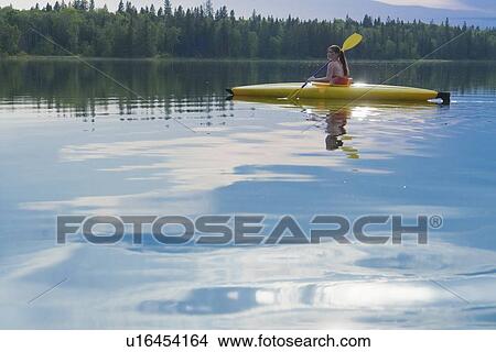 Picture - Young woman in kayak on Lake Katherine, Riding Mountain National Park, Manitoba, Canada. Fotosearch