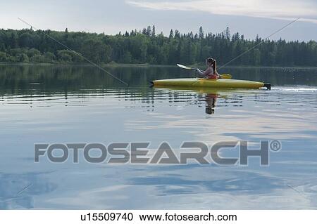 Young woman paddling in kayak on Lake Katherine, Riding Mountain National Park, Manitoba, Canada View Large Photo Image Stock Image - Young woman paddling in kayak on Lake Katherine, Riding Mountain National Park, Manitoba, Canada. Fotosearch