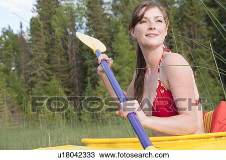 Young woman paddling in yellow kayak, Lake Katherine, Riding Mountain National Park, Manitoba, Canada View Large Photo Image Stock Image - Young woman paddling in yellow kayak, Lake Katherine, Riding Mountain National Park, Manitoba, Canada. Fotosearch