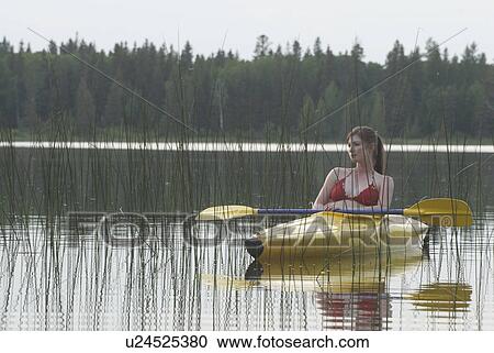 Young woman takes a break in her yellow kayak, Lake Katherine, Riding Mountain National Park, Manitoba, Canada View Large Photo Image Stock Image - Young woman takes a break in her yellow kayak, Lake Katherine, Riding Mountain National Park, Manitoba, Canada. Fotosearch
