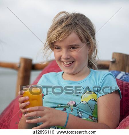 Stock Photograph - 9 year old girl smiling at camera. Fotosearch