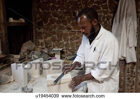 Stock Photo - African man working on crafts. Fotosearch