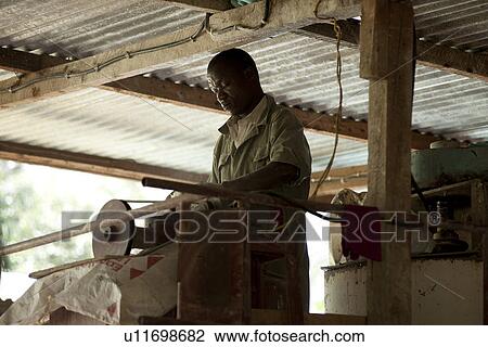 African man working with machinery View Large Photo Image Stock Image - African man working with machinery. Fotosearch