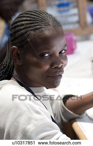 Stock Image - African woman looking at the camera. Fotosearch
