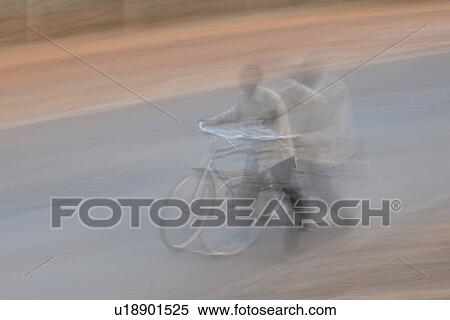 Stock Photography - Blurred picture of African man with a bicycle. Fotosearch