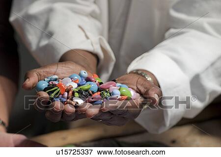 Stock Photo - Hands holding colorful beads. Fotosearch