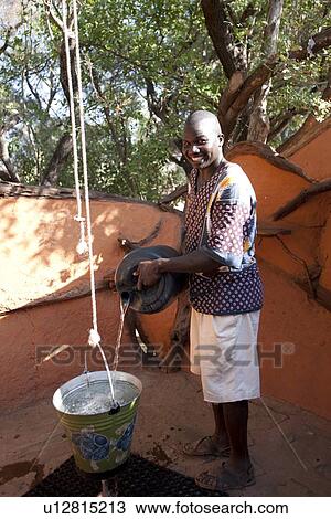 Kenyan man cleaning up View Large Photo Image Stock Image - Kenyan man cleaning up. Fotosearch
