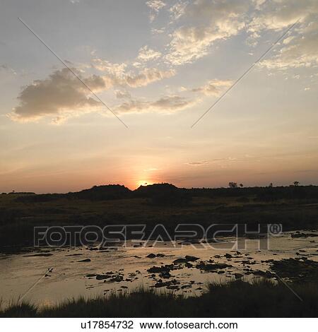 Stock Image - Mara River at sunset in Kenya Africa. Fotosearch