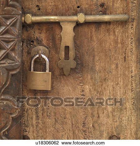 Stock Image - Padlock on door in Lamu Town, Kenya Africa. Fotosearch