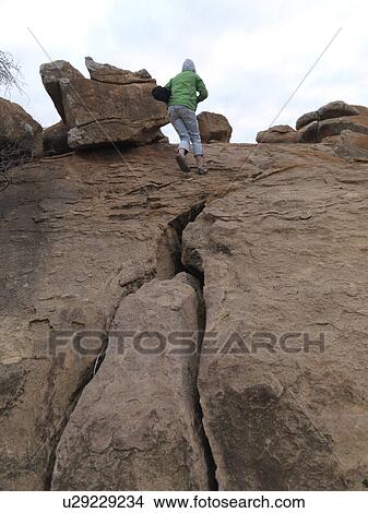 Picture - Person standing on top of hill in Kenya Africa. Fotosearch