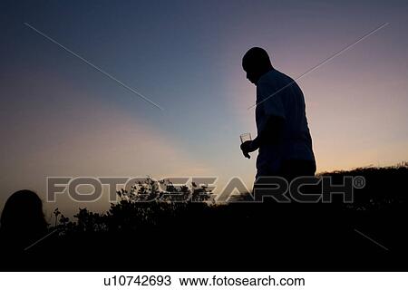 Silhouette of man against Kenya sky at sunset View Large Photo Image Stock Image - Silhouette of man against Kenya sky at sunset. Fotosearch