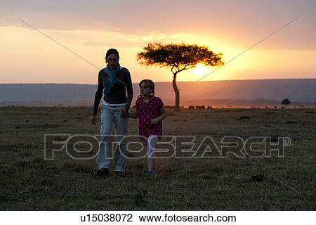 Sillouette of people against sunset sky in Kenya View Large Photo Image Stock Image - Sillouette of people against sunset sky in Kenya. Fotosearch