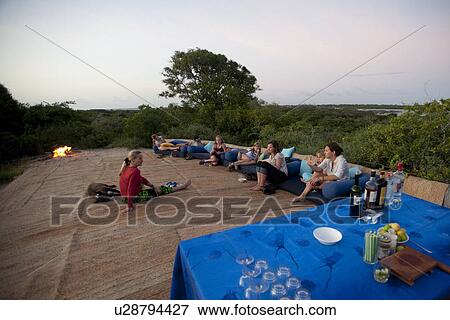 Stock Photo - Tourists on lounge chairs at Manda Bay Resort in Kenya Africa. Fotosearch