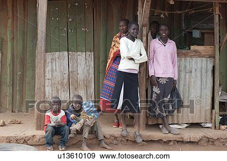 Villagers by hut in Kenya View Large Photo Image Stock Photo - Villagers by hut in Kenya. Fotosearch