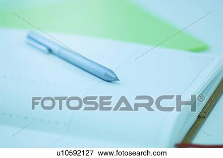 Stock Photo - A notebook and a pen. Fotosearch
