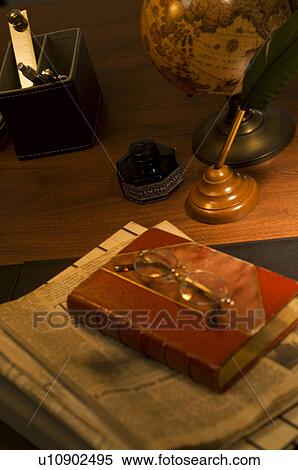 Antique book on desk with newspaper View Large Photo Image Stock Photography - Antique book on desk with newspaper. Fotosearch