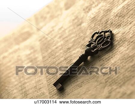 Antique key on a newspaper View Large Photo Image Picture - Antique key on a newspaper. Fotosearch