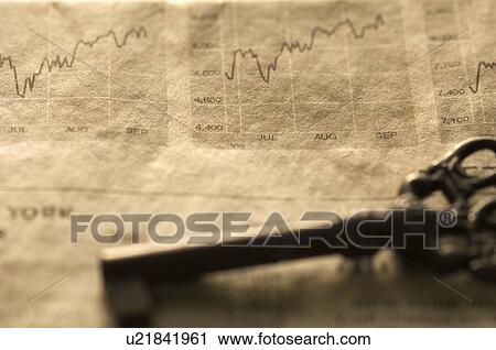Stock Image - Antique key on a newspaper. Fotosearch