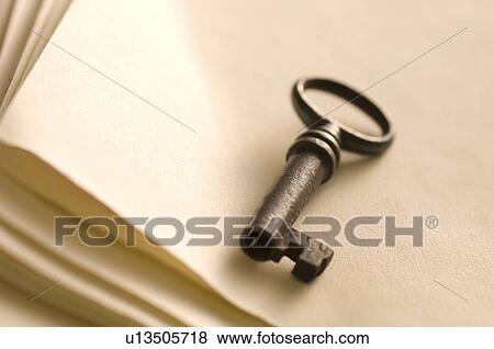 Stock Photo - Antique key on a notebook. Fotosearch