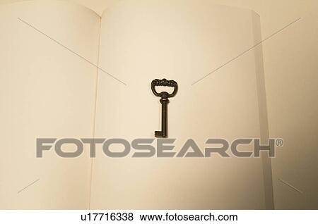Antique key on a notebook View Large Photo Image Stock Photo - Antique key on a notebook. Fotosearch