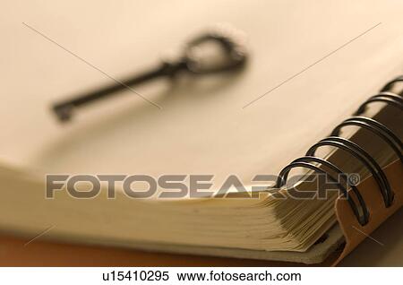 Antique key on a notebook View Large Photo Image Stock Photography - Antique key on a notebook. Fotosearch