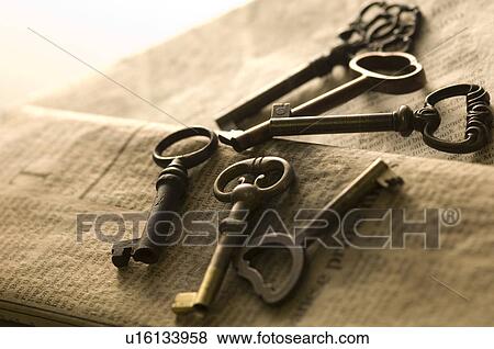 Antique keys on a newspaper View Large Photo Image Stock Photo - Antique keys on a newspaper. Fotosearch