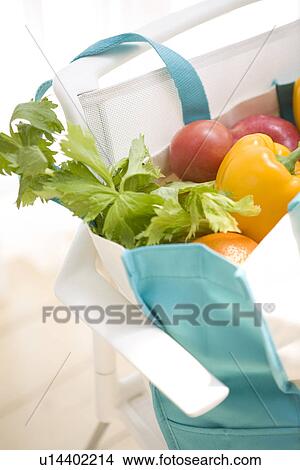 Picture - Bag of vegetables on chair. Fotosearch