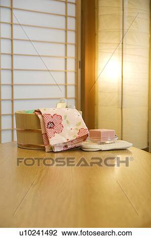 Stock Image - Bamboo bucket of bath products in a health spa. Fotosearch
