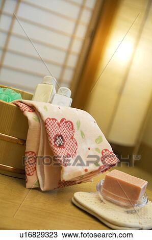 Stock Image - Bamboo bucket of bath products in a health spa. Fotosearch