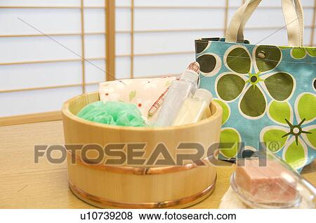 Stock Photo - Bamboo bucket of bath products in a health spa. Fotosearch