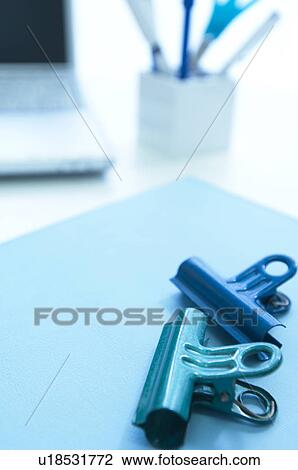 Binder clips on desk View Large Photo Image Stock Image - Binder clips on desk. Fotosearch