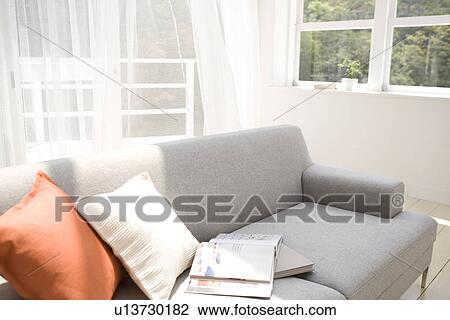Books on sofa in living room View Large Photo Image Stock Image - Books on sofa in living room. Fotosearch