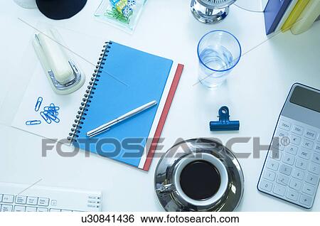 Business desk with coffee, water and office supplies View Large Photo Image Stock Photograph - Business desk with coffee, water and office supplies. Fotosearch