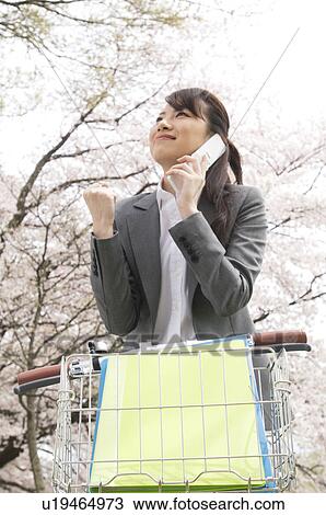 Businesswoman talking on cellphone in a field View Large Photo Image Stock Image - Businesswoman talking on cellphone in a field. Fotosearch