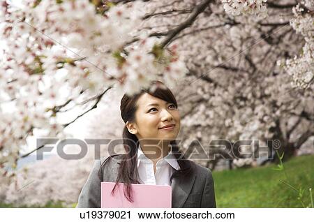 Businesswoman with some paperwork in a field View Large Photo Image Stock Image - Businesswoman with some paperwork in a field. Fotosearch
