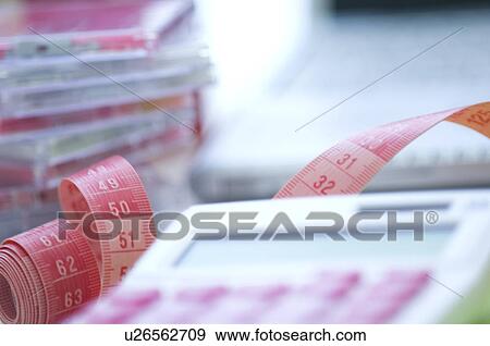Calculator and tape measure on desk View Large Photo Image Stock Photo - Calculator and tape measure on desk. Fotosearch