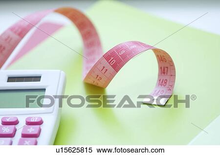 Calculator and tape measure on desk View Large Photo Image Stock Photography - Calculator and tape measure on desk. Fotosearch