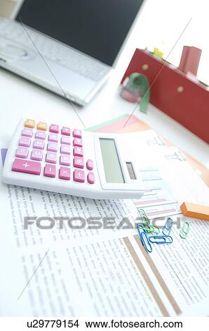 Calculator, laptop and files on desk View Large Photo Image Picture - Calculator, laptop and files on desk. Fotosearch