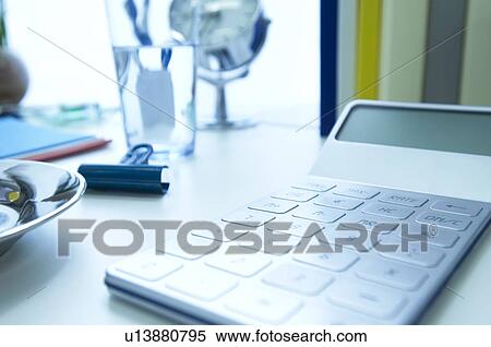 Stock Photography - Calculator on office desk. Fotosearch