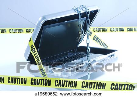 Stock Image - Case with laptop covered in chains and cordon tape. Fotosearch
