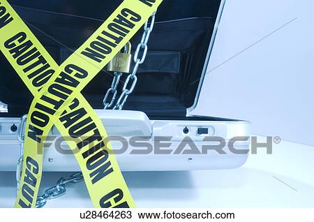 Case with laptop covered in chains and cordon tape View Large Photo Image Stock Image - Case with laptop covered in chains and cordon tape. Fotosearch