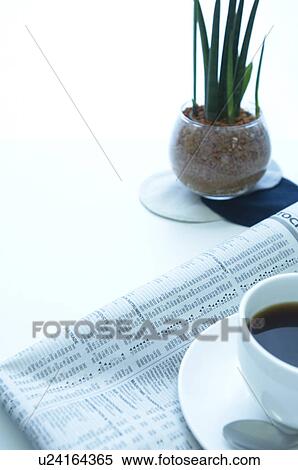 Stock Photography - Coffee and newspaper on desk. Fotosearch